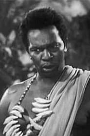Martin Wilkins as Chaka, the Witch Doctor
