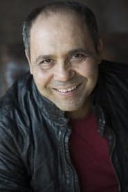 Kamel Benchemekh as Grocer