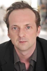 Cyril Couton as The Bookstore Owner