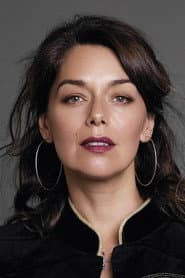 Elvira Cristi as Earrings Vendor